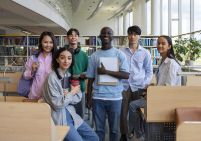 full-shot-smiley-students-library (1)